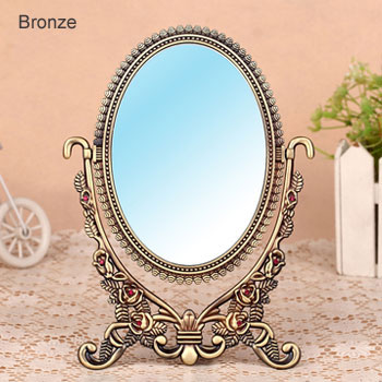Specchi da tavolo antichi con struttura in metallo intagliato in bronzo ovale